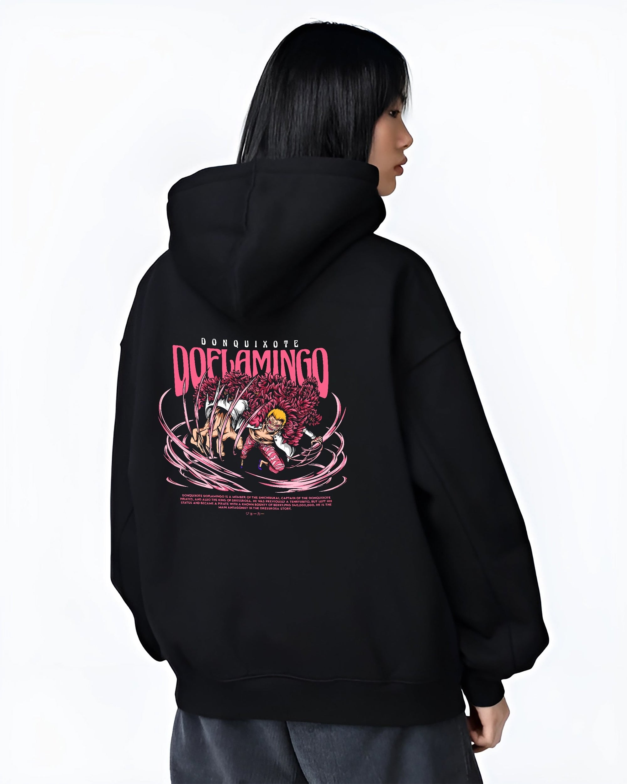 Black hoodie worn by a female model, back view, featuring One Piece Doflamingo anime poster inspired design with pink feather coat and shonen battle manga aesthetic.