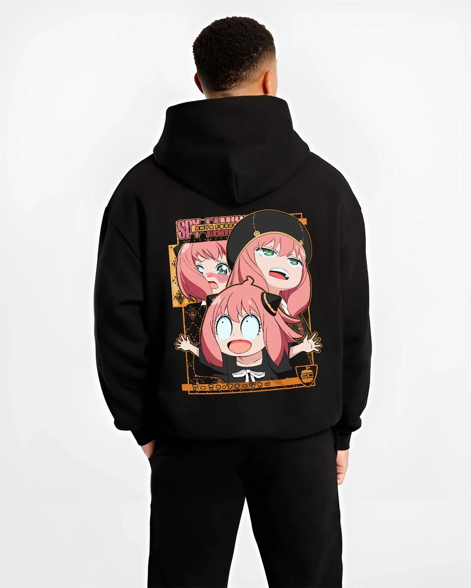 Black hoodie worn by male model, back view with Anya Forger Hoodie Spy x Family Funny Faces Expression graphic bold anime graphic.