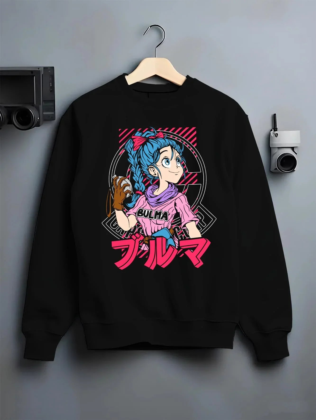 Black crewneck sweatshirt on hanger with Bulma Hoodie Dragon Ball Z Pink Outfit Capsule Corp graphic streetwear graphic.
