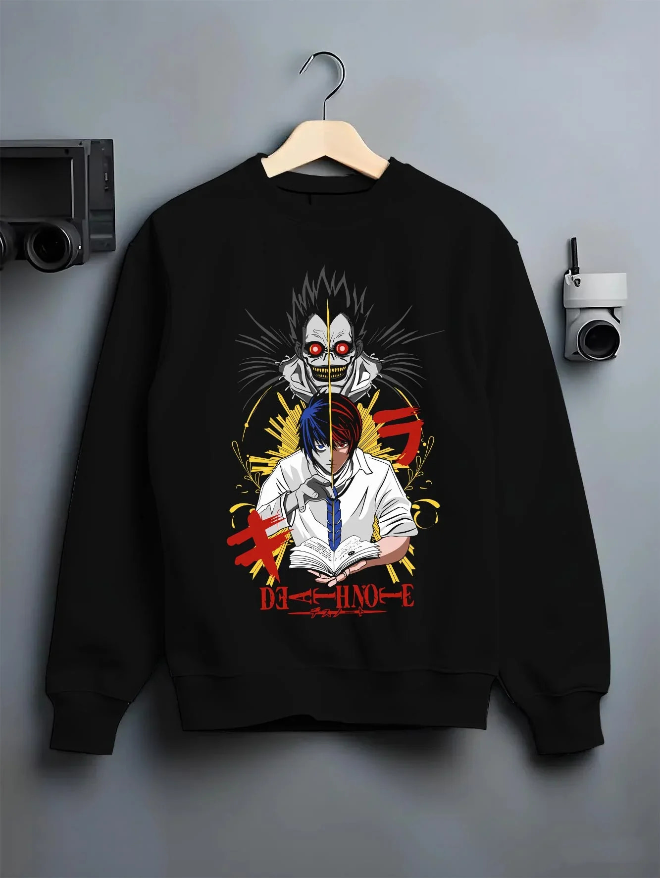 Black crewneck sweatshirt on hanger with Ryuk Hoodie Death Note Retro Anime Shinigami Poster graphic bold anime graphic.