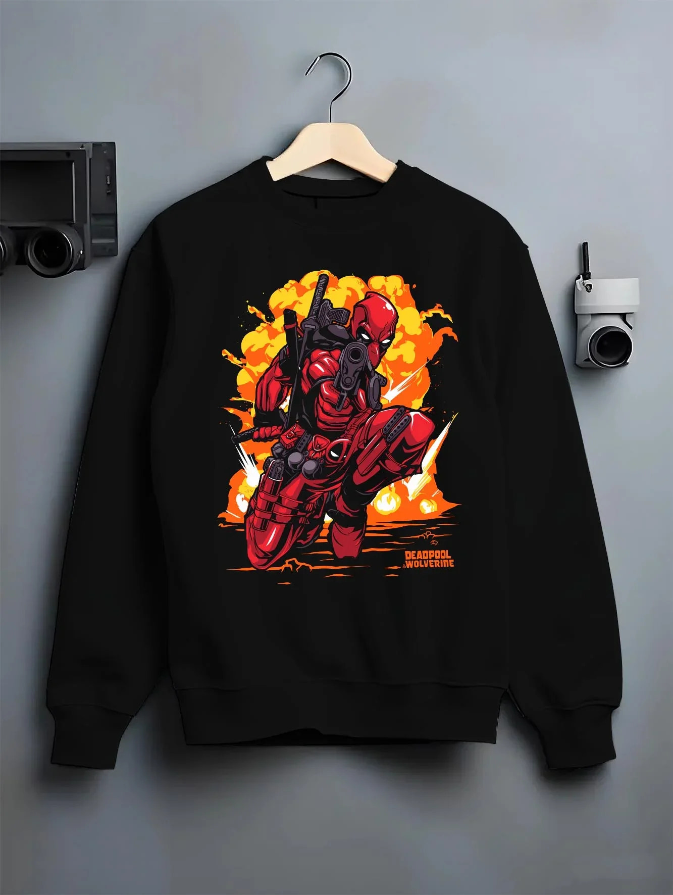 Black crewneck sweatshirt on hanger with Deadpool Hoodie Marvel Anime Cross Retro Parody Art graphic streetwear graphic.
