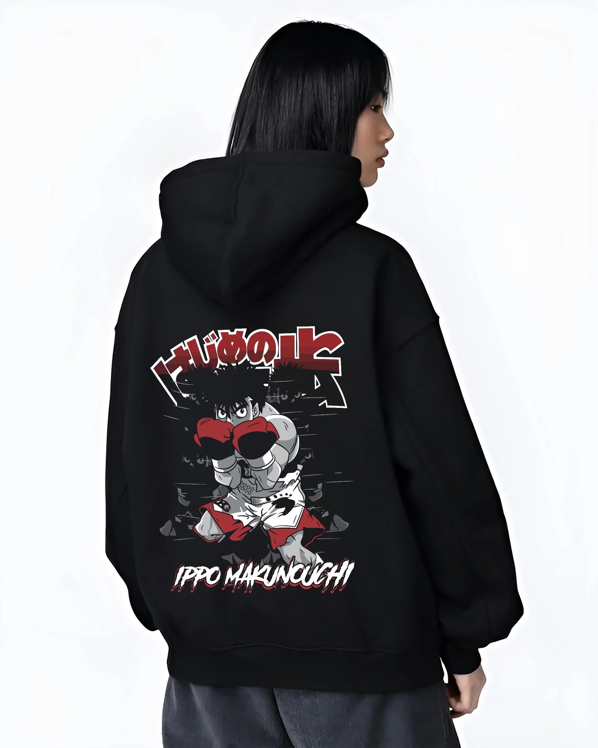 Black hoodie worn by female model, back view with Hajime no Ippo Hoodie Ippo Makunouchi Determined graphic premium wear.