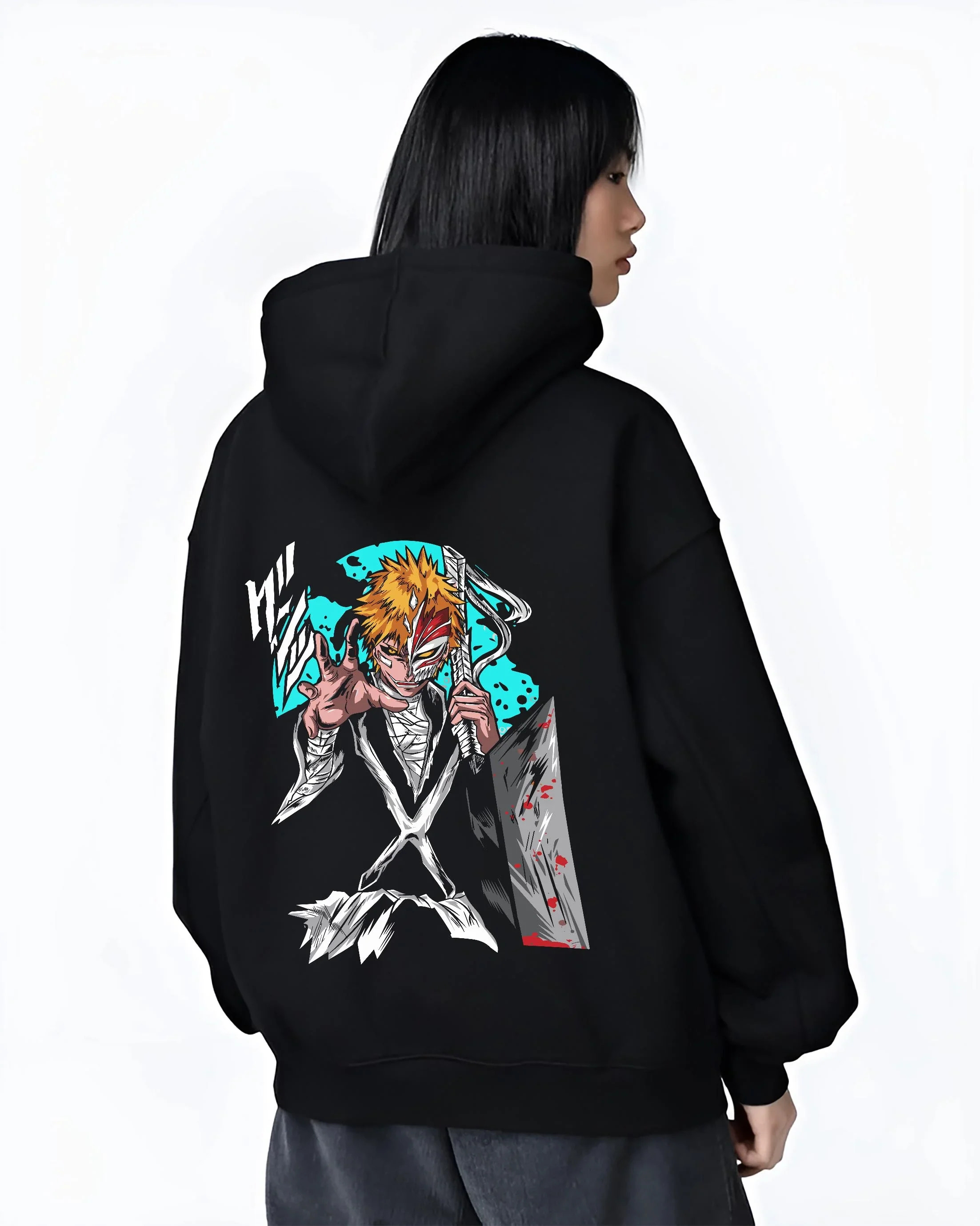 Black hoodie worn by female model, back view with Ichigo Hollow Mask Hoodie Bleach Anime Warrior Jumper graphic bold anime graphic.