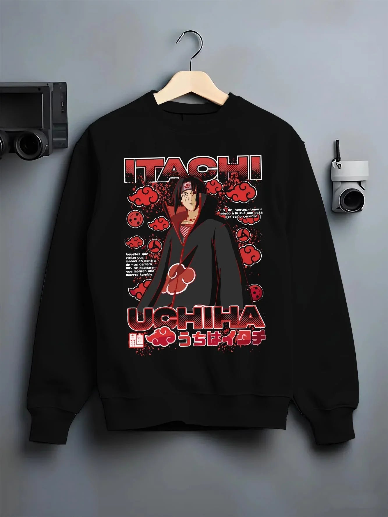 Black crewneck sweatshirt on hanger with Naruto Hoodie Itachi Uchiha Akatsuki Clan Jumper graphic bold anime graphic.