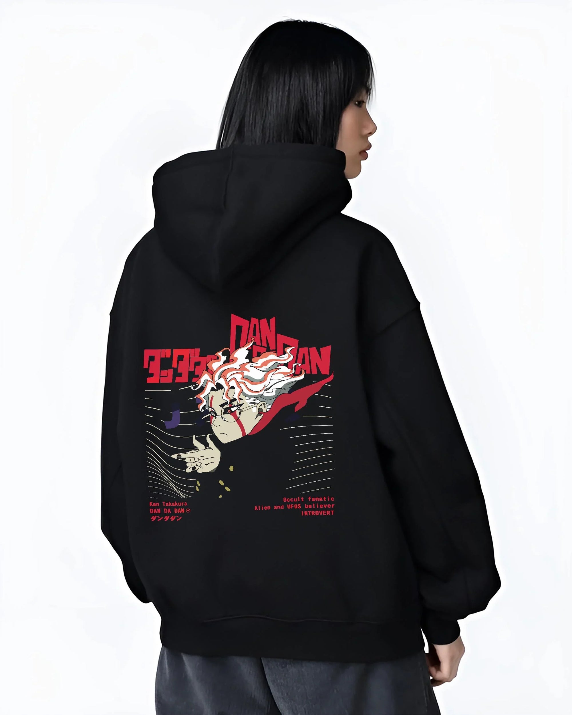 Black hoodie worn by female model, back view with Ken Takakura Dandadan Hoodie Occult UFO Believer Retro graphic streetwear graphic.