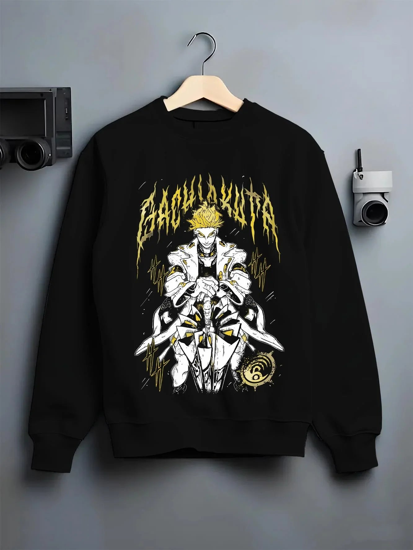 Black crewneck sweatshirt on hanger with Rudo Hoodie Gachiakuta Skeletal Yellow Art graphic streetwear graphic.