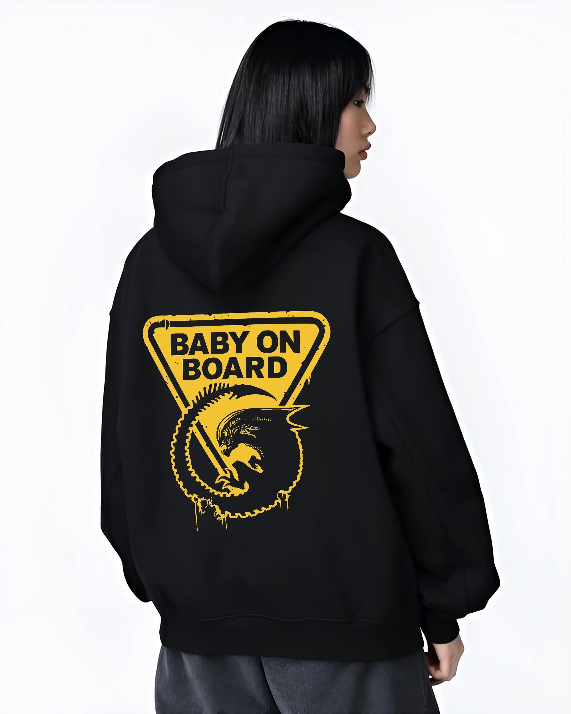 Black T-shirt on male model, back view, Alien baby on board warning sign retro sci-fi graphic with triangle frame and drips.