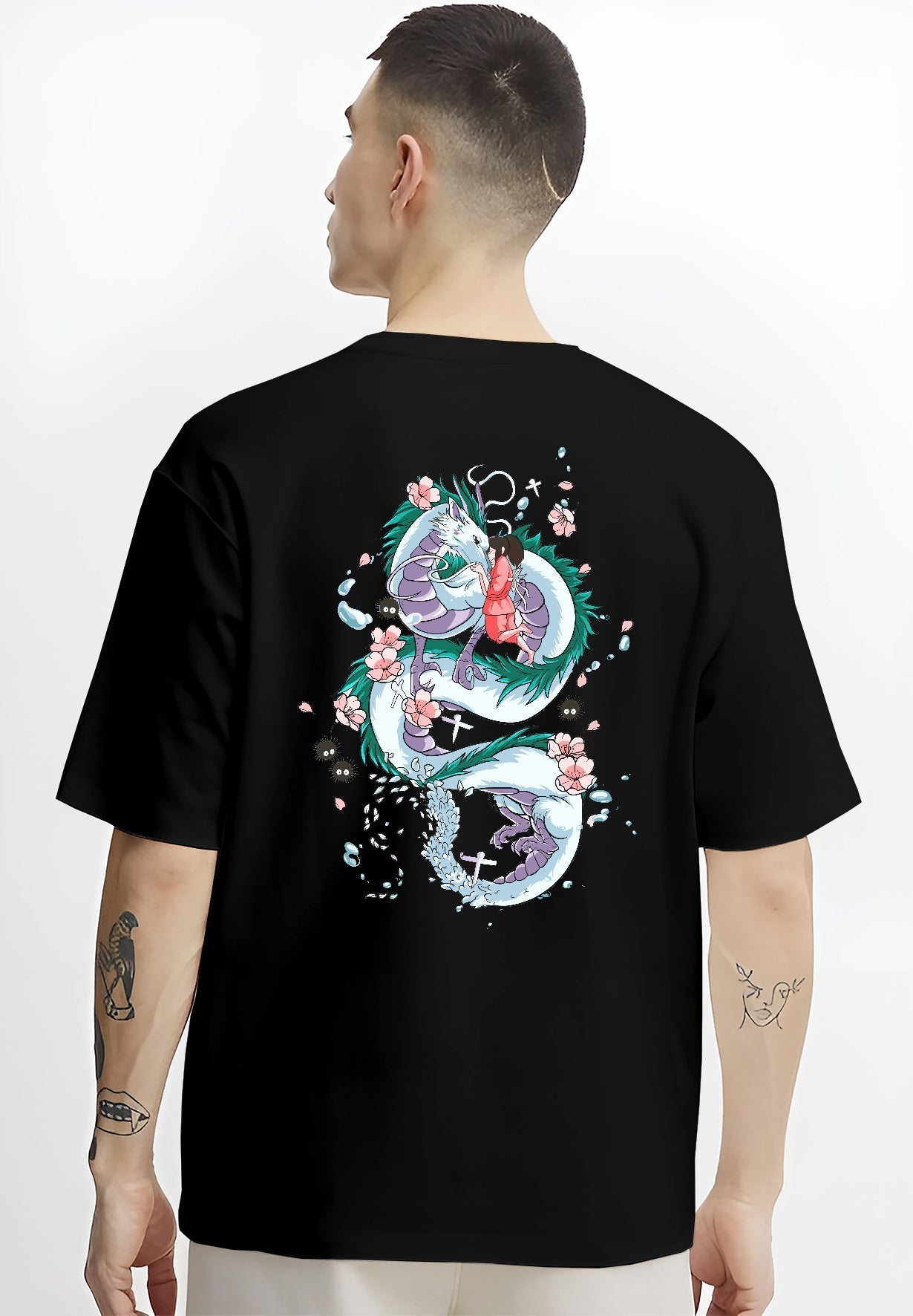 Black T-shirt on male model, back view, Spirited Away Haku dragon with Chihiro retro manga artwork framed by blossoms.