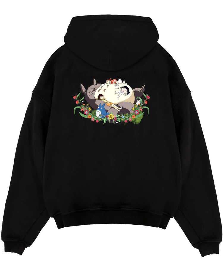 Black pullover hoodie laid flat on white background, featuring Totoro nap scene with friends, nostalgic 90s floral Japanese animation streetwear.